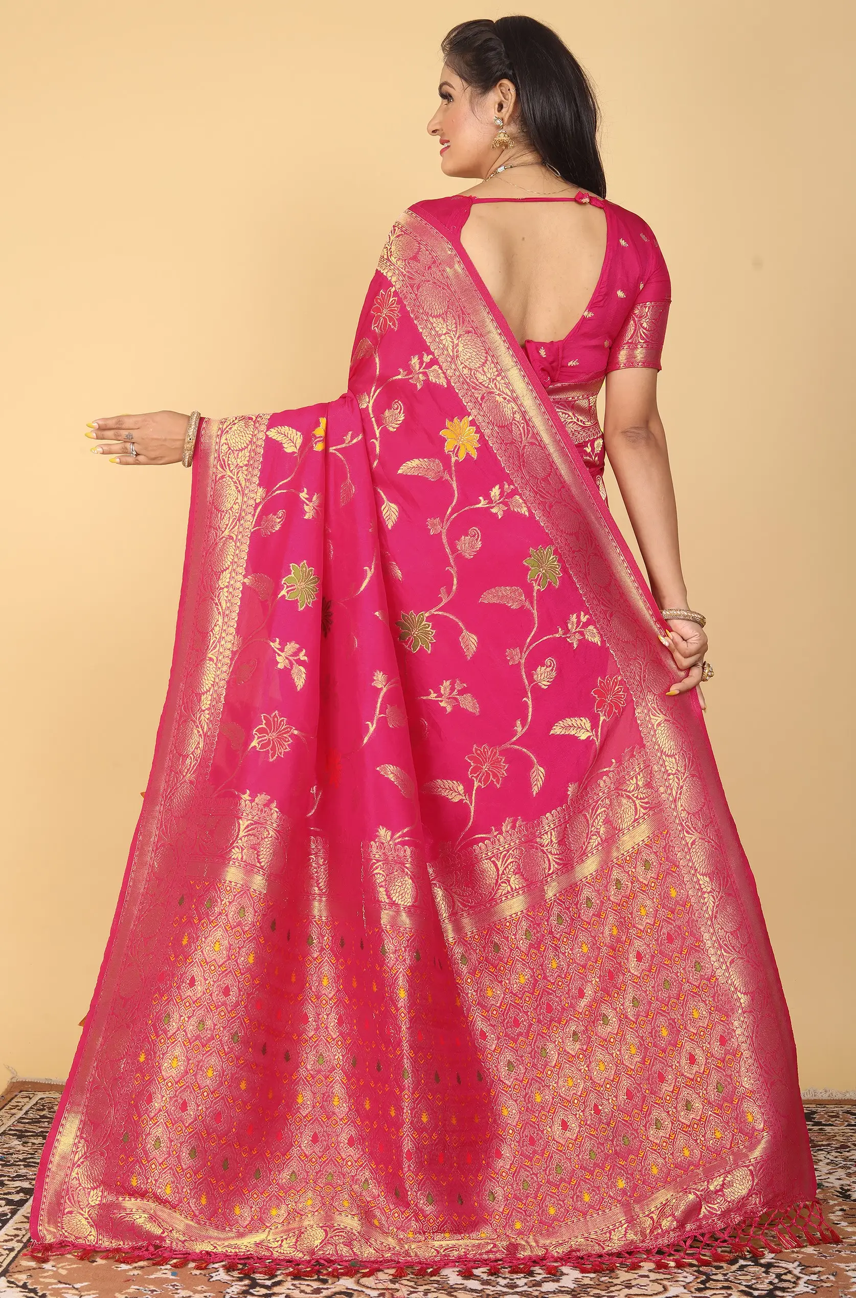 rani pink dola silk saree with floral motifs silver zari border and tassel pallu