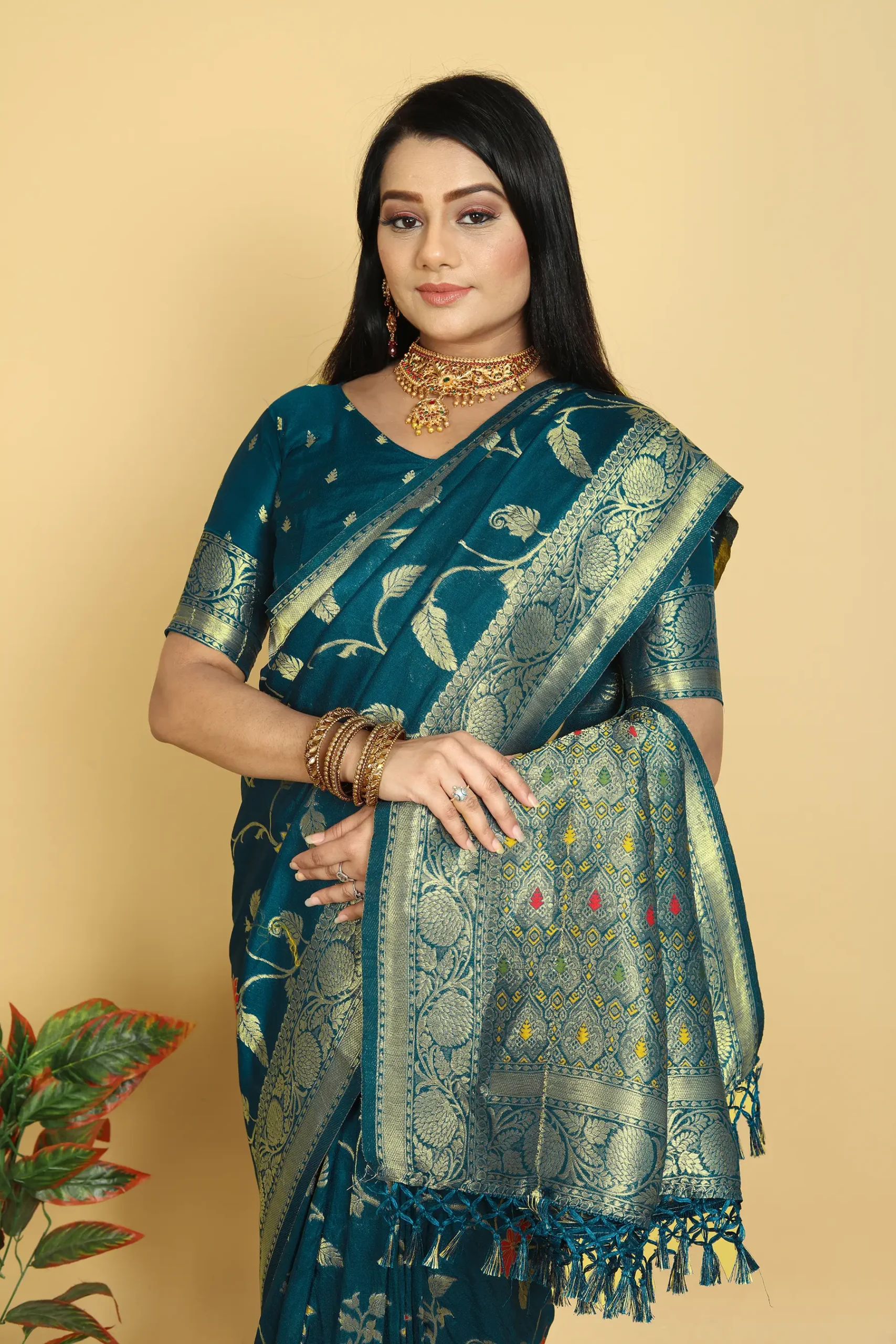 teal dola silk saree with floral motifs silver zari border and tassel pallu