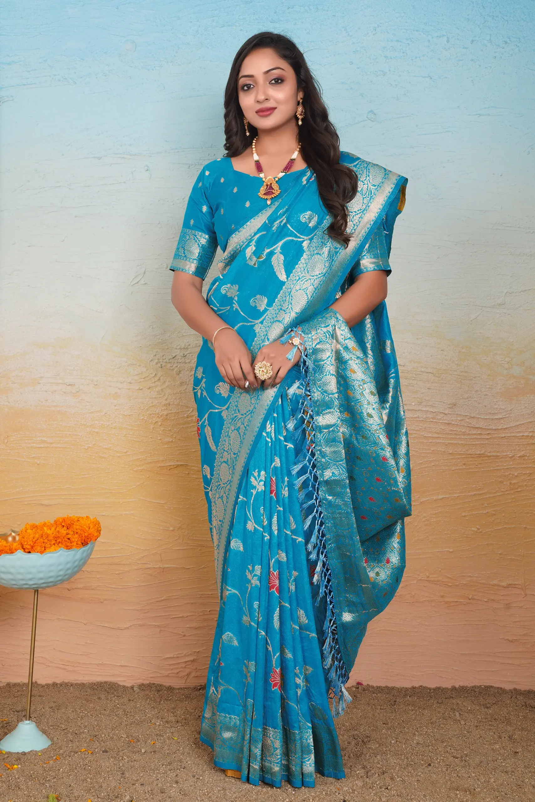 acqua blue dola silk saree with floral motifs silver zari border and tassel pallu