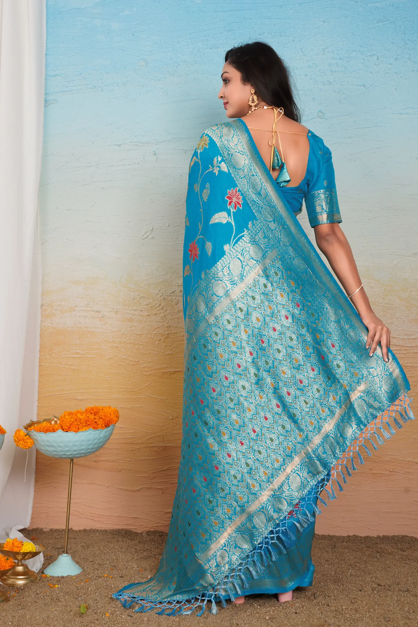 acqua blue dola silk saree with floral motifs silver zari border and tassel pallu
