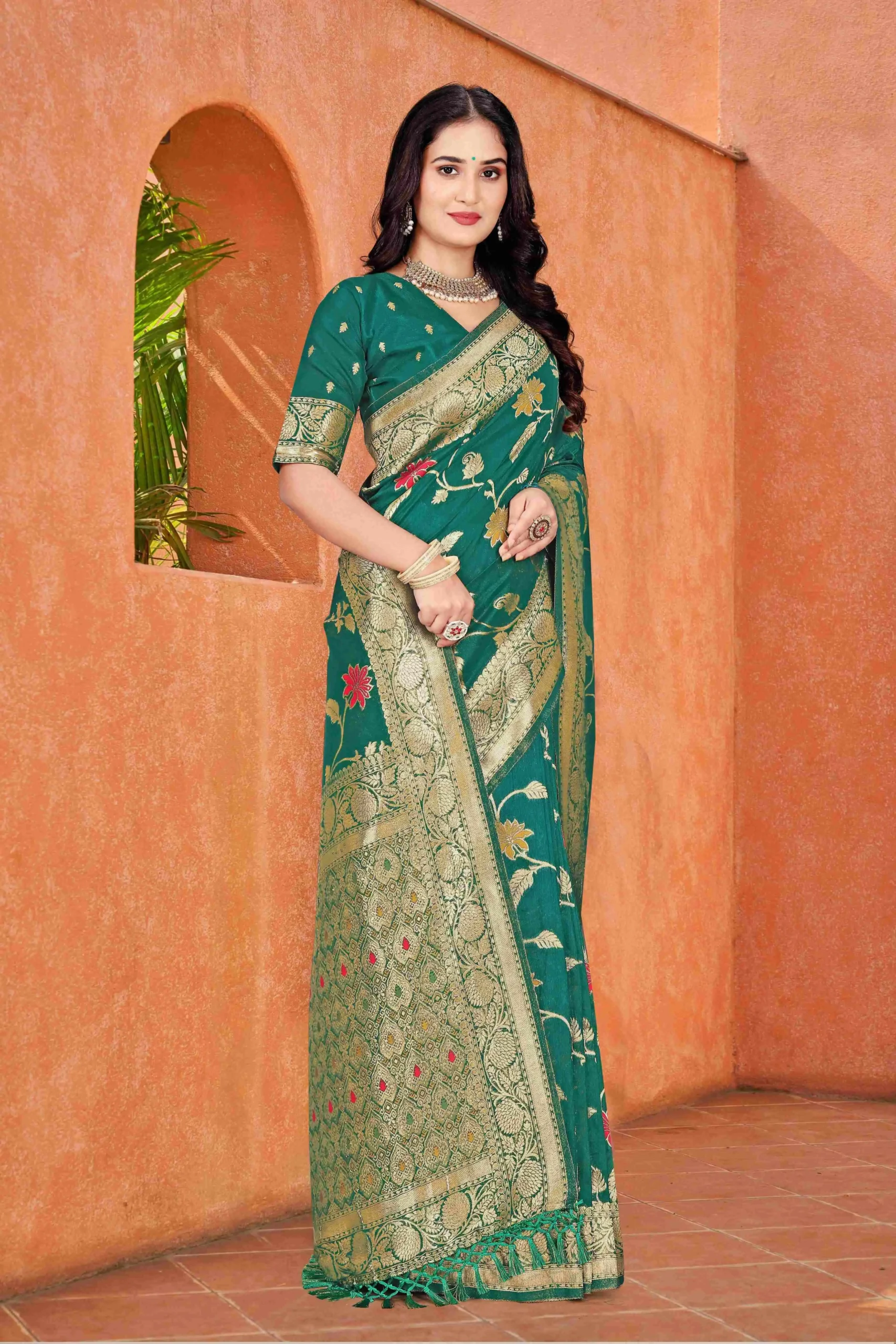 dark green dola silk saree with floral motifs silver zari border and tassel pallu